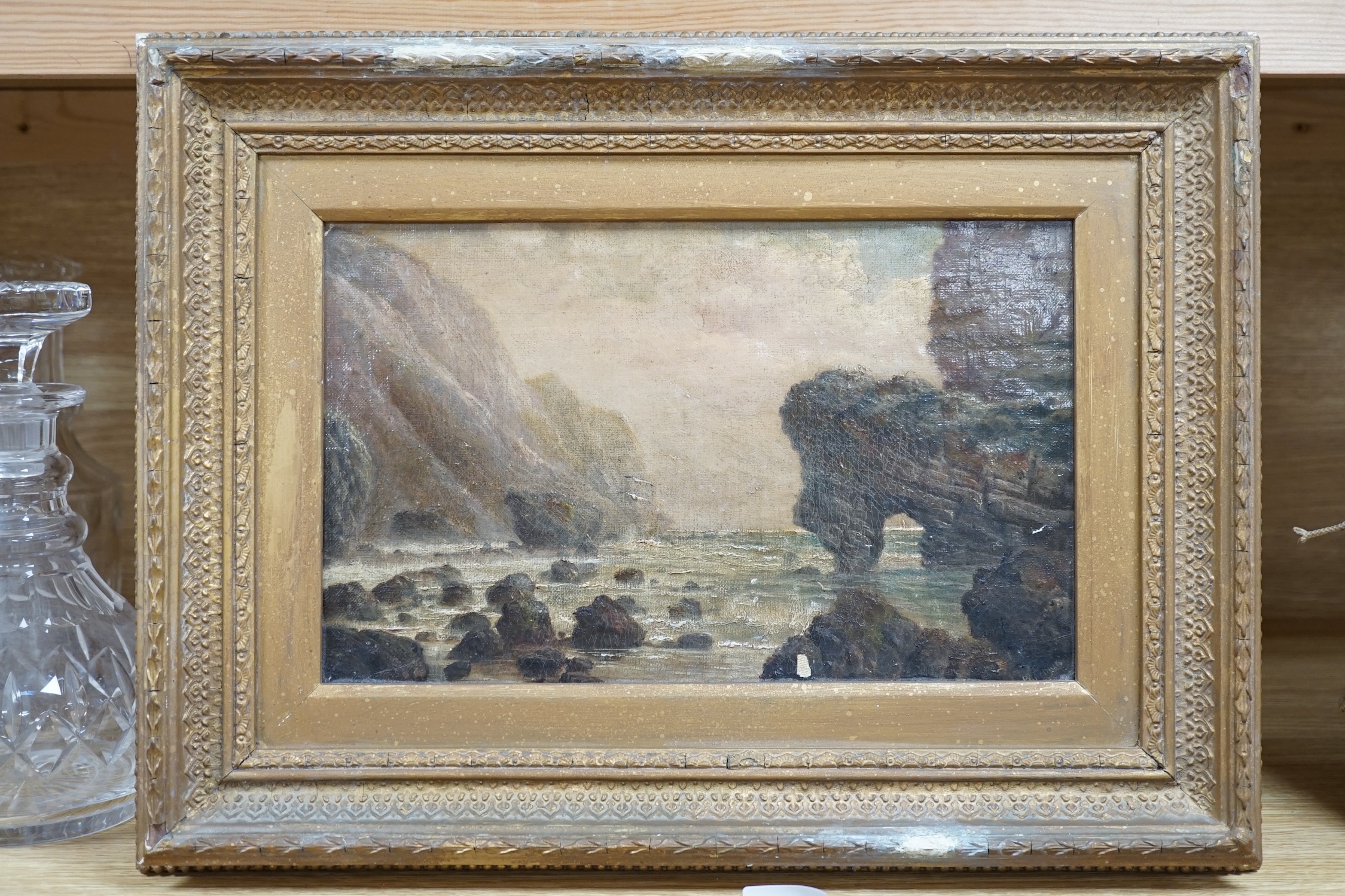 19th century English School, oil on board, Dorset Jurassic coast, showing a coastal rock formation similar to Durdle Door, 18 x 29cm, gilt frame. Condition - fair, some paint chips